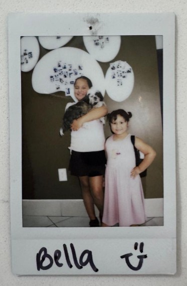 two girls one dog smiling