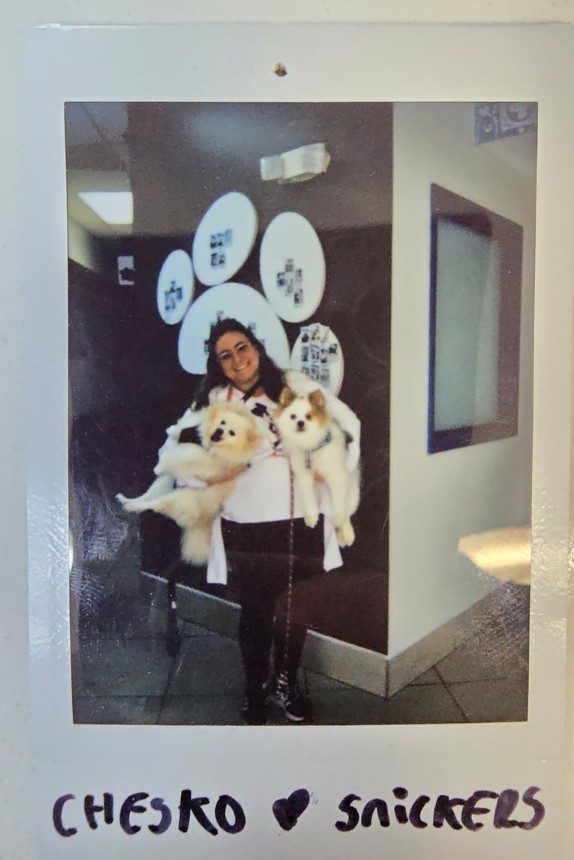 woman holding two dogs