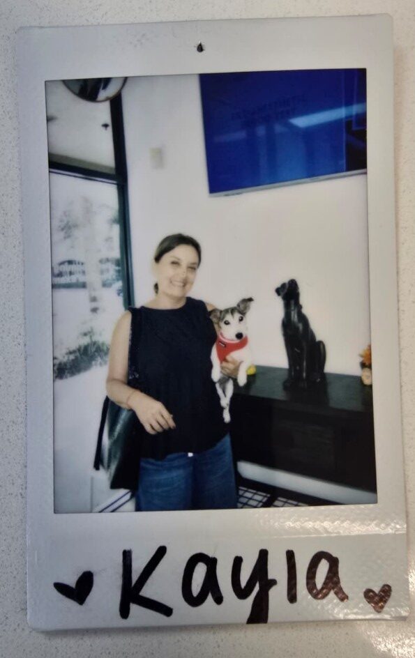 woman holds small dog